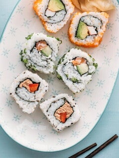 Sushi Bowl con Ensalada de Surimi y Batido Sushi en un bowl con palillos chinos a un lado