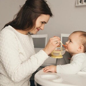 mamá dando de comer a bebé mamá dando de comer a bebé