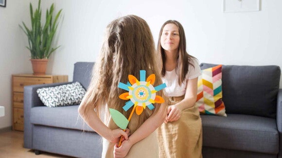 Una hija entregándole a su madre una actividad de arte para niños Una hija entregándole a su madre una actividad de arte para niños